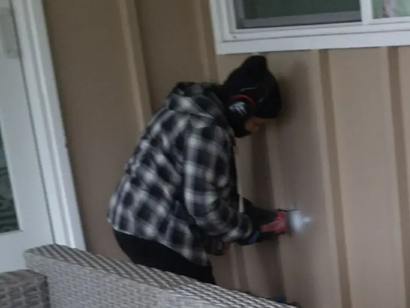 Professional electrician installing an exterior outlet in Flat Rock